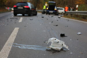 Autounfall auf Straße mit verstreutem Trümmerfeld